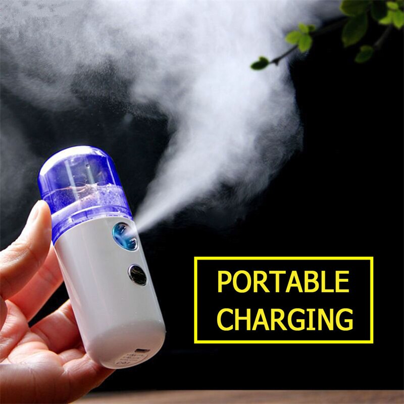 A hand holding a Piw Wee 30ml Mini Face Spray with a purple lid, emitting a fine mist. Text next to the sprayer reads "PORTABLE CHARGING" in yellow on a black background. This travel-friendly gadget provides deep moisture on the go.